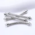 Detailed view of silver-plated curved tube connectors with paved cubic zirconia - Platinum Plated
