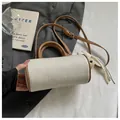 Stylish small cylindrical crossbody bag in beige woven texture with brown leather trim - No Pendant / White