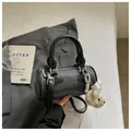 Trendy black barrel bag for women with cute rabbit charm and textured finish - With Charm / Black