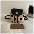 Fashionable cream polka dot backpack featuring a black flap and metal chain handle - Without Charm Style / Beige
