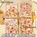Detail von vier A7-Spiralnotizbüchern mit süßen Capybara-Illustrationen in warmen Tönen - Wasserschwein Thema / 1本装