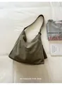 Detailed view of an olive green canvas hobo bag in a relaxed lifestyle flat lay - Green