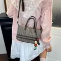 Chic hollow-out woven tote bag in brown and beige featuring stylish bead and chain charms - Beaded Pendant Style / Coffee With Rabbit Pendant