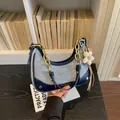 Elegant denim and navy blue leather hobo shoulder bag featuring a stylish gold chain strap - With Pendant / Blue