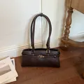 Minimalist dark brown underarm tote bag with gold-tone lock detail, 2026 fashion - Basic Style / Coffee
