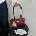 Minimalist burgundy faux leather underarm tote bag with a cute dog plush keychain - With Pendant / Red
