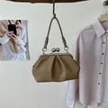 Elegant tan pleated handbag featuring a classic kiss-lock closure and shoulder strap - Khaki