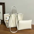 Elegant cream white leather tote bag with matching pouch and cute dog charm for daily commute - Tote Bag Set (Includes Pouch & Charm) / White