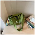 Green checkered canvas shoulder bag with white logo and cute doll charm for daily commute. - With Charm / Green