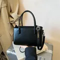 Elegante zwarte minimalistische handtas voor dames met handvatten en schouderriem - Zwart