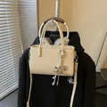 Small cream crossbody handbag with stylish rocking horse charm for daily use and commute - Khaki With Pendant