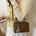 Elegant brown structured small handbag for women with a stylish silver horse charm - Brown with Charm
