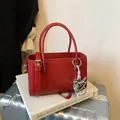 Elegant red structured top handle handbag with silver horse charm for office wear - Red With Pendant