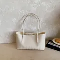 Large beige woven tote bag with wavy edges and long shoulder straps for daily commute - White