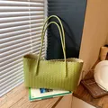 Large avocado green woven tote bag with wavy top edge and slim shoulder straps. - Green