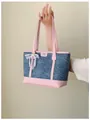 Stylish denim tote bag featuring pink leather trim and a delicate pearl bow charm. - With Charm / Pink