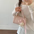 Chic pink barrel pillow handbag featuring cute plush dog charm and tassel decoration - With Pendant / Pink