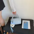 Fashionable light blue cylinder pillow bag for women with adorable plush bear charm - With Pendant / Blue
