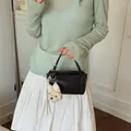 Elegant black cylinder pillow bag for women featuring a cute plush bear charm accessory. - With Pendant / Black