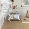 Stylish silver metallic Boston handbag with a cute plush keychain for a trendy daily commute look - With Charm Style / Silver