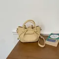 Elegant creamy yellow leather bucket bag with knotted handles for women - Yellow
