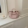 Elegant pink pebble leather bucket handbag with drawstring detail for women - Pink