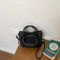 Elegant black pebble leather bucket bag for daily commute and stylish office wear. - Black