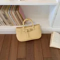 Elegant pale yellow pebbled leather handbag with buckle detail for women's daily style - Yellow