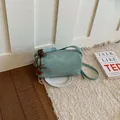 Stylish mint green pillow shaped crossbody bag with a cute red strawberry charm - With Pendant / Green