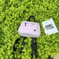 Lightweight lavender small multi-functional backpack displayed on green lush leaves - Small Purple