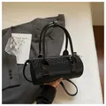 Elegant black cylindrical barrel handbag featuring star patterns and silver hardware details - Regular Fit / Black