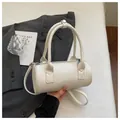 Elegant white cylindrical handbag with star pattern texture, top handle and shoulder strap. - Regular Fit / White