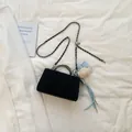 Elegant black quilted square mini bag featuring a silver chain strap and light blue bow charm - No Pendant / Black