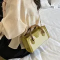 Stylish straw woven beach bag with bamboo handles and crossbody strap. - Green