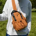 Stylish ginger orange nylon outdoor chest bag featuring a front drawstring pocket detail - Brown