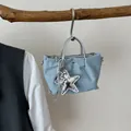 Casual light blue denim dumpling bag with silver handles and metallic star pendant - Medium (With Pendant) / Silver