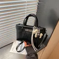 Elegant black crinkled faux leather commuter handbag with decorative animal charm - With Keychain / Black