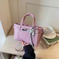 Elegant soft pink pebbled leather commuter handbag featuring a silver lock and horse charm - With Keychain / Pink