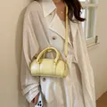 Stylish light yellow textured leather bolster handbag with crossbody strap for women - Without Pendant / Yellow
