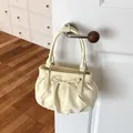 Sweet cream polka dot bucket handbag with decorative bow detail hanging on a door handle - No Pendant / Yellow