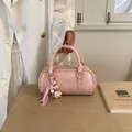 Stylish pink glossy pillow handbag for women featuring a cute heart charm and gold hardware - With Charm / Pink