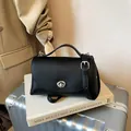 Elegant black pebbled leather crossbody bag with silver-tone turn-lock closure. - Basic Style / Black