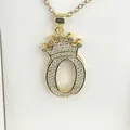 Close-up of a gold-plated letter O pendant with crown and shimmering cubic zirconia stones - Letter O / Gold