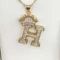 Close-up of a gold-plated letter H pendant necklace decorated with zircon crown detail - Letter H / Gold