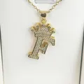 Close-up of gold-plated crown letter F pendant with clear zircon stones on a chain. - Letter F / Gold