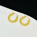 Detailed close-up showing the metallic texture of French style twisted gold hoop earrings - French Twisted Hoop Style (7766)