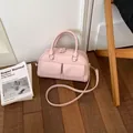 Stylish minimalist pink Boston handbag featuring dual front pockets and adjustable strap - Without Pendant / Pink