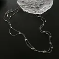 Vintage style layered silver necklace with metallic bead accents on a dark surface - Triple Row Layered Necklace (8344) / 120cm / Steel