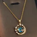 Detailed macro shot of a golden dream planet pendant with blue cosmic texture - Dreamy Round Star