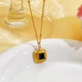 Close-up of a French retro gold necklace featuring a square green glass stone pendant - Black Glass Stone Necklace (EH156) / Gold